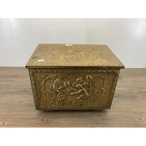 409 - A mid 20th century embossed brass coal box - approx. 29cm high x 40.5cm wide x 28cm deep