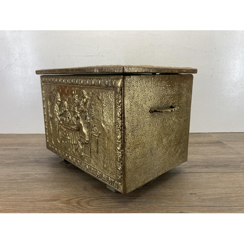 409 - A mid 20th century embossed brass coal box - approx. 29cm high x 40.5cm wide x 28cm deep