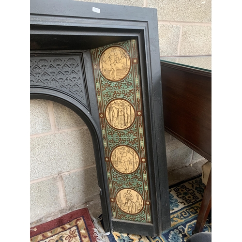 1 - A Victorian cast iron fire surround with ceramic tile inserts - approx. 100cm high x 102cm wide