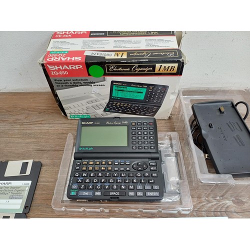 807 - A boxed Sharp ZQ-650 1mb electronic organizer and CE-60K organizer link with ten floppy discs