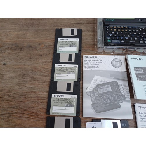 807 - A boxed Sharp ZQ-650 1mb electronic organizer and CE-60K organizer link with ten floppy discs