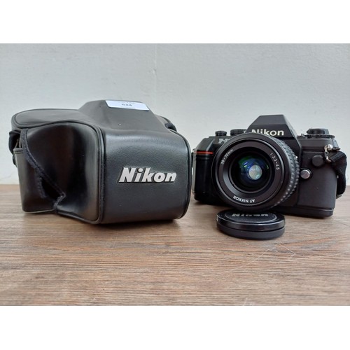 624 - A cased Nikon F-301 35mm SLR camera fitted with Nikkor AF 1:3.3-4.5 35-70mm lens