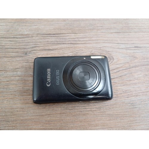 627 - Two boxed Canon IXUS 130 14.1mp compact digital cameras with batteries, chargers, software discs and... 