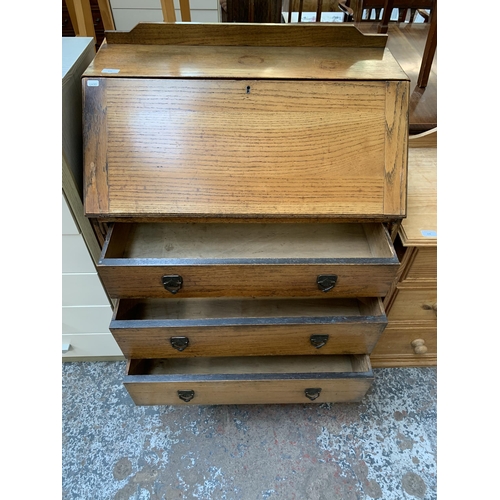 148 - An early 20th century oak bureau - approx. 106cm high x 76cm wide x 42cm deep