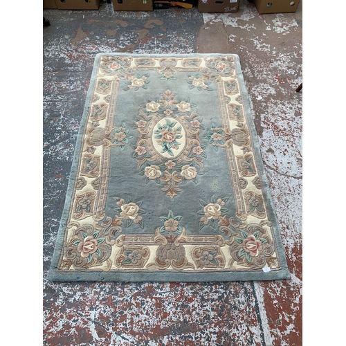 243B - A Chinese floral pattern rug - approx. 6ft x 4ft