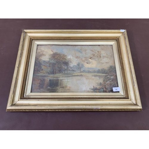 277 - A late 19th/early 20th century gilt framed oil painting of a lake scene - approx. 48cm high x 65cm w... 