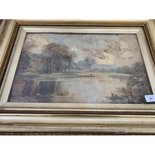 277 - A late 19th/early 20th century gilt framed oil painting of a lake scene - approx. 48cm high x 65cm w... 