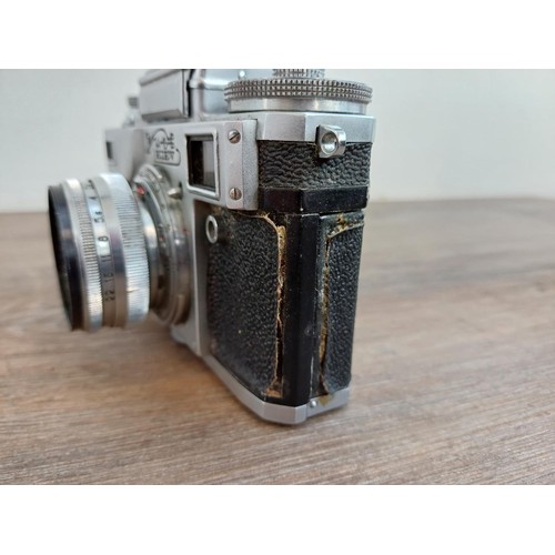 633 - A cased 1974 Zavod Arsenal Kiev 4 35mm rangefinder camera (serial number 7417607) fitted with Jupite... 