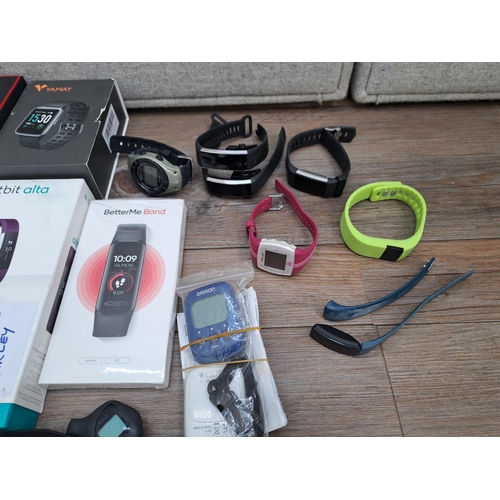 766 - A collection of smart watches, heart rate monitors and fitness trackers to include two boxed Fitbit ... 