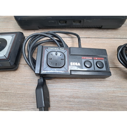 776 - A SEGA Master System II with three controllers