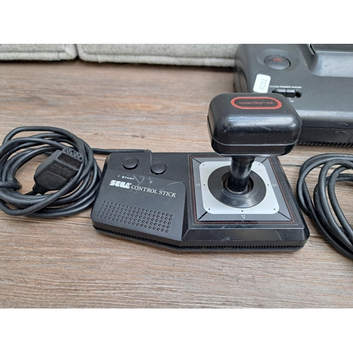 776 - A SEGA Master System II with three controllers