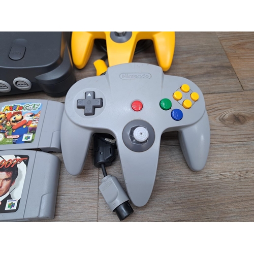 777 - A Nintendo 64 console with two controllers, power supply, Controller Pak and four games; The Legend ... 