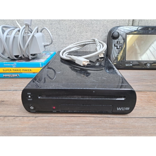 778 - A Nintendo Wii U WUP-101(03) console with gamepad, console AC adapter and three games; Minecraft Wii... 