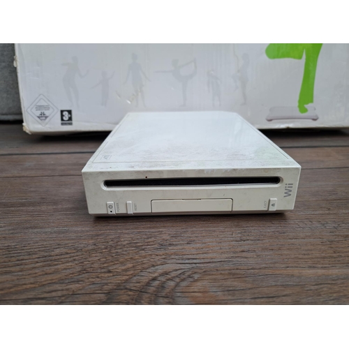 779 - A boxed Nintendo Wii console with boxed Wii Fit unit, controllers and games