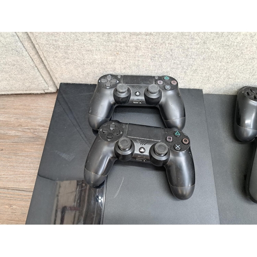 782 - Two Sony PlayStation 4 consoles, one CUH-1116A and one CUH-2016A one third-party and three official ... 