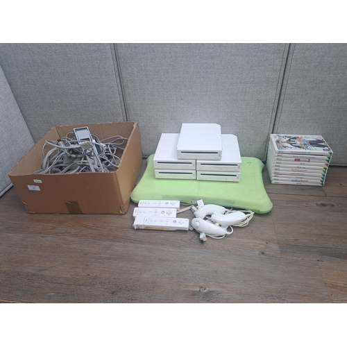 795 - Five Nintendo Wii consoles with Wii Fit board, controllers, games and accessories etc.