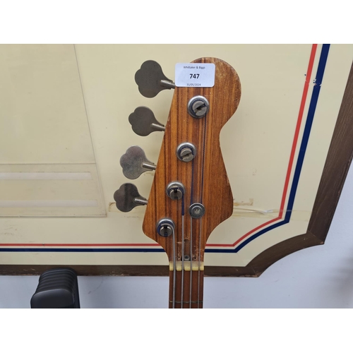 747 - A cased electric bass guitar with guitar and microphone stands and Bomaker sound bar