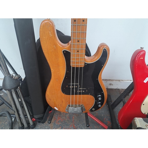 747 - A cased electric bass guitar with guitar and microphone stands and Bomaker sound bar