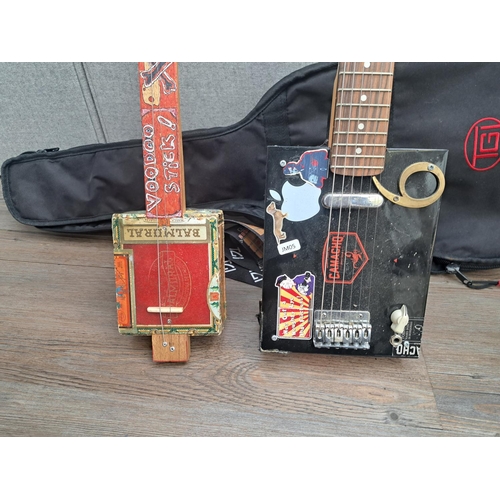 762 - Two cigar box guitars with one TGI case, one electric six-string with guitar neck and Camacho box an... 