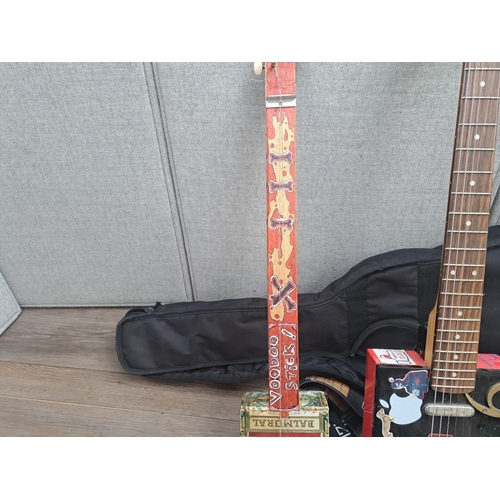 762 - Two cigar box guitars with one TGI case, one electric six-string with guitar neck and Camacho box an... 