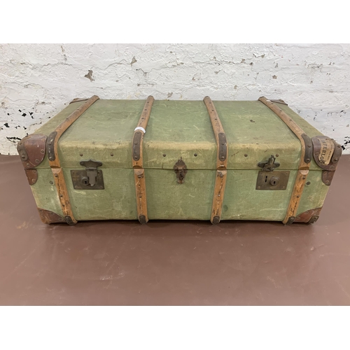 100 - An early 20th century green canvas and beech banded travel trunk - approx. 33cm high x 93cm wide x 5... 