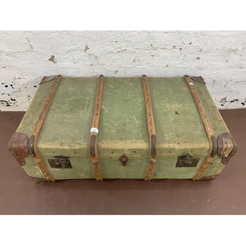 100 - An early 20th century green canvas and beech banded travel trunk - approx. 33cm high x 93cm wide x 5... 