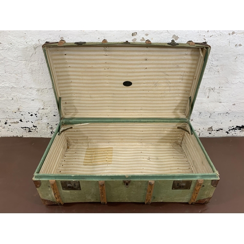 100 - An early 20th century green canvas and beech banded travel trunk - approx. 33cm high x 93cm wide x 5... 