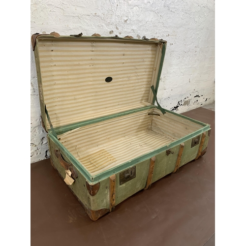 100 - An early 20th century green canvas and beech banded travel trunk - approx. 33cm high x 93cm wide x 5... 