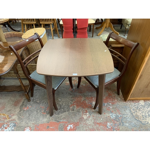 103 - Three pieces of furniture, one walnut effect dining table and two mahogany dining chairs