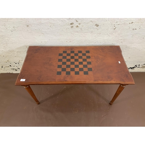 106 - A 19th century style burr walnut effect games coffee table - approx. 55cm high x 50cm wide x 100cm l... 