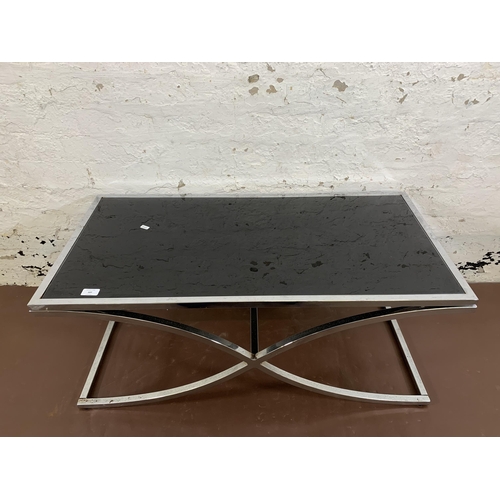 107 - A modern chrome plated and black glass rectangular coffee table