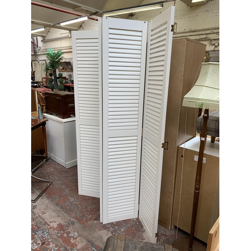 108 - A white laminate four section folding dressing screen - approx. 207cm high x 160cm wide