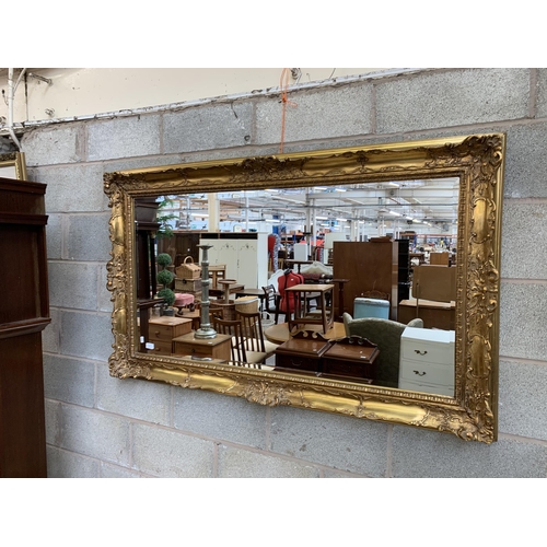 11 - A 19th century style gilt framed bevelled edge wall mirror - approx. 87cm high x 147cm wide