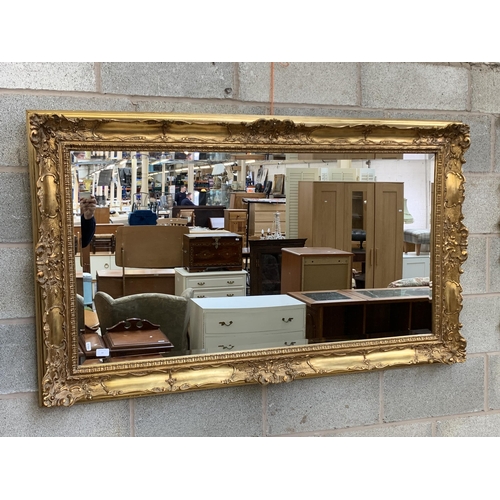 11 - A 19th century style gilt framed bevelled edge wall mirror - approx. 87cm high x 147cm wide