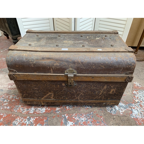 111 - An early 20th century brown metal travel trunk