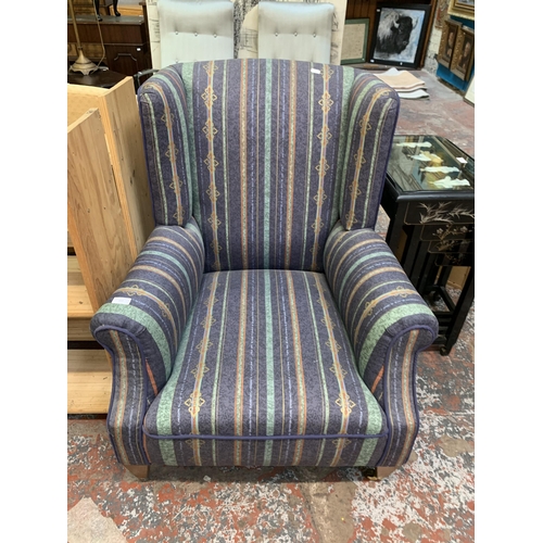 113 - A Victorian style fabric upholstered wingback armchair