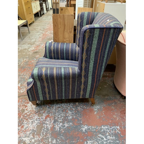 113 - A Victorian style fabric upholstered wingback armchair