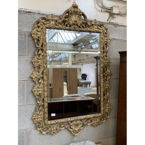 12 - A Rococo style gilt framed bevelled edge wall mirror - approx. 138cm high x 90cm wide