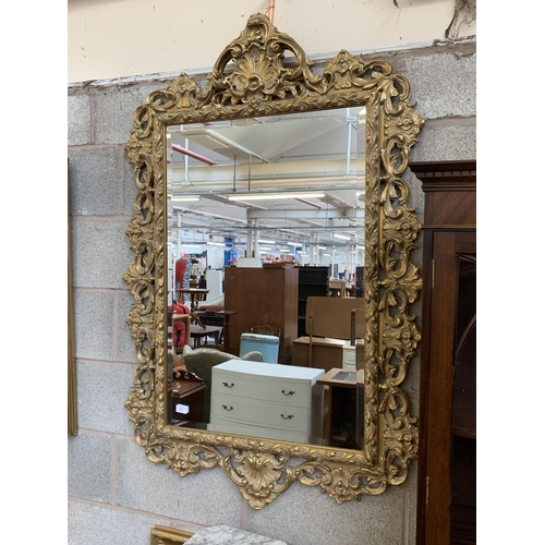 12 - A Rococo style gilt framed bevelled edge wall mirror - approx. 138cm high x 90cm wide