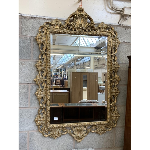 12 - A Rococo style gilt framed bevelled edge wall mirror - approx. 138cm high x 90cm wide