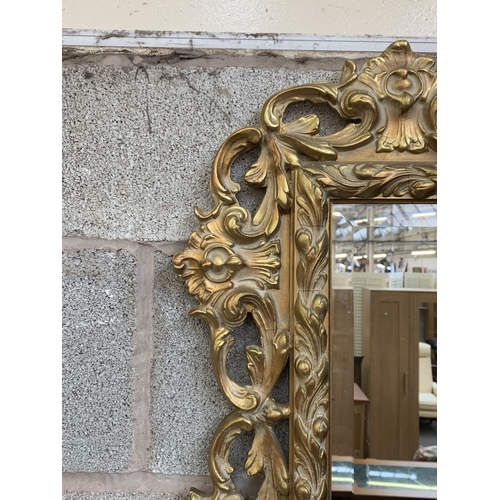 12 - A Rococo style gilt framed bevelled edge wall mirror - approx. 138cm high x 90cm wide