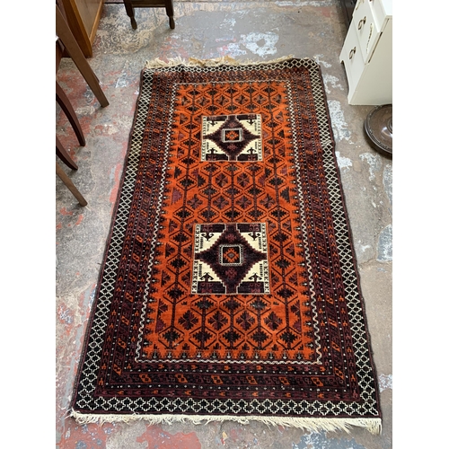 124 - A mid 20th century hand knotted rug - approx. 190cm x 110cm