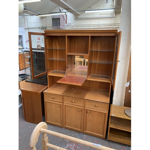 133 - A mid 20th century teak display unit