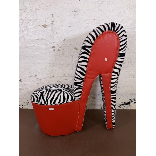 136 - A modern red leatherette and zebra striped fabric high heel shoe occasional chair - approx. 96cm hig... 