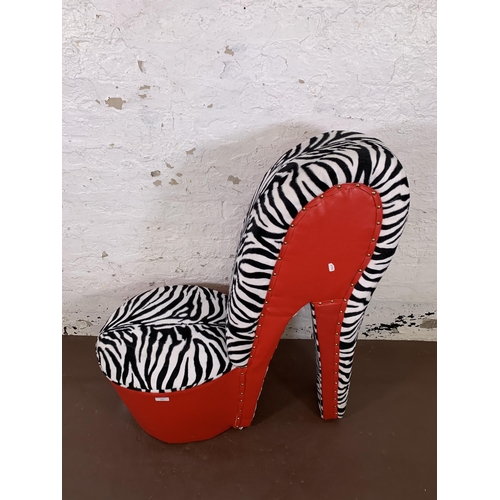 136 - A modern red leatherette and zebra striped fabric high heel shoe occasional chair - approx. 96cm hig... 