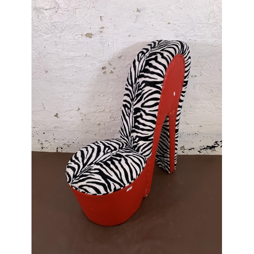 136 - A modern red leatherette and zebra striped fabric high heel shoe occasional chair - approx. 96cm hig... 