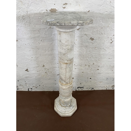 16 - A 19th century style marble column jardinière stand with octagonal top and base - approx. 100cm high... 