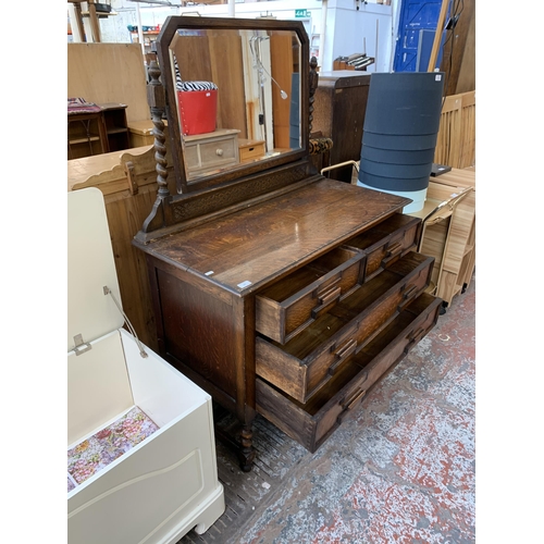 165 - An early 20th century Jacobean revival carved oak dressing table - approx. 142cm high x 106cm wide x... 