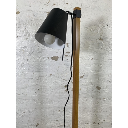 168 - A GoodHome oak effect and black metal floor lamp - approx. 126cm high