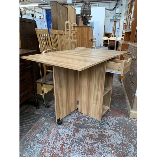 169 - A modern oak effect drop leaf dining table